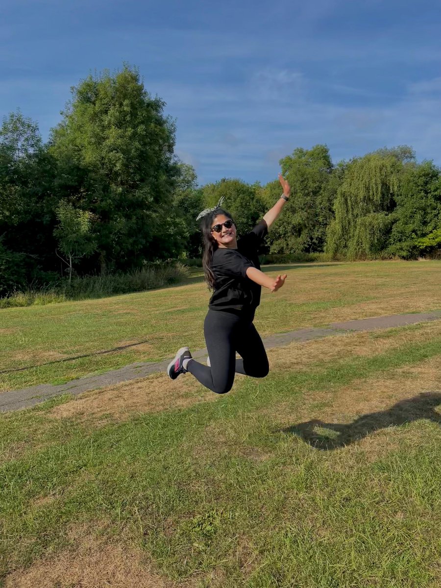 Safia jumping for joy in a sunlit park