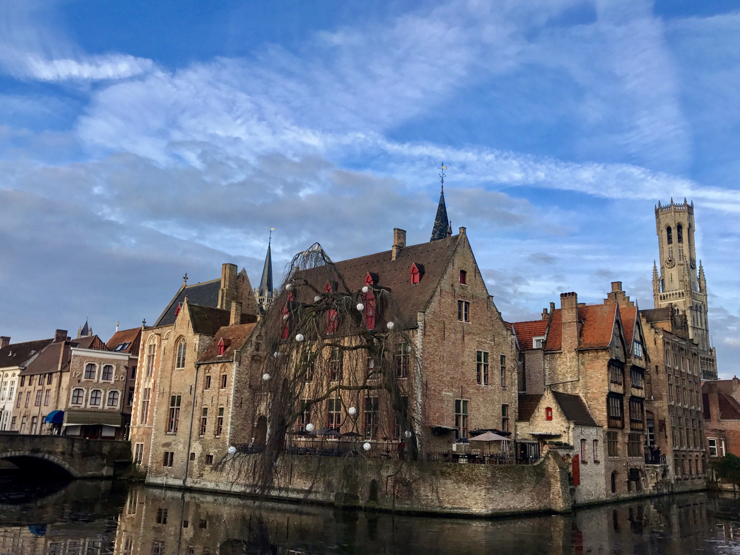 View of lovely hotel and bar next toWollestraat Bridge & canal in Bruges, Belgium